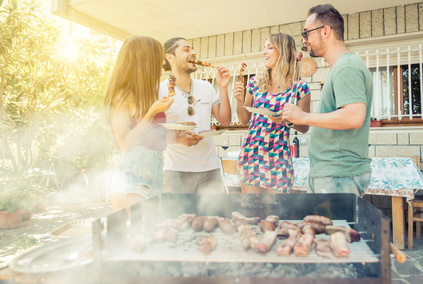 Group of friend having lunch in the backyard